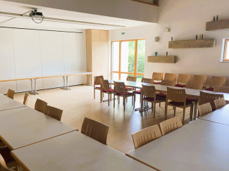 leere Tische und Stühle im großen Saal des Gemeindezentrums